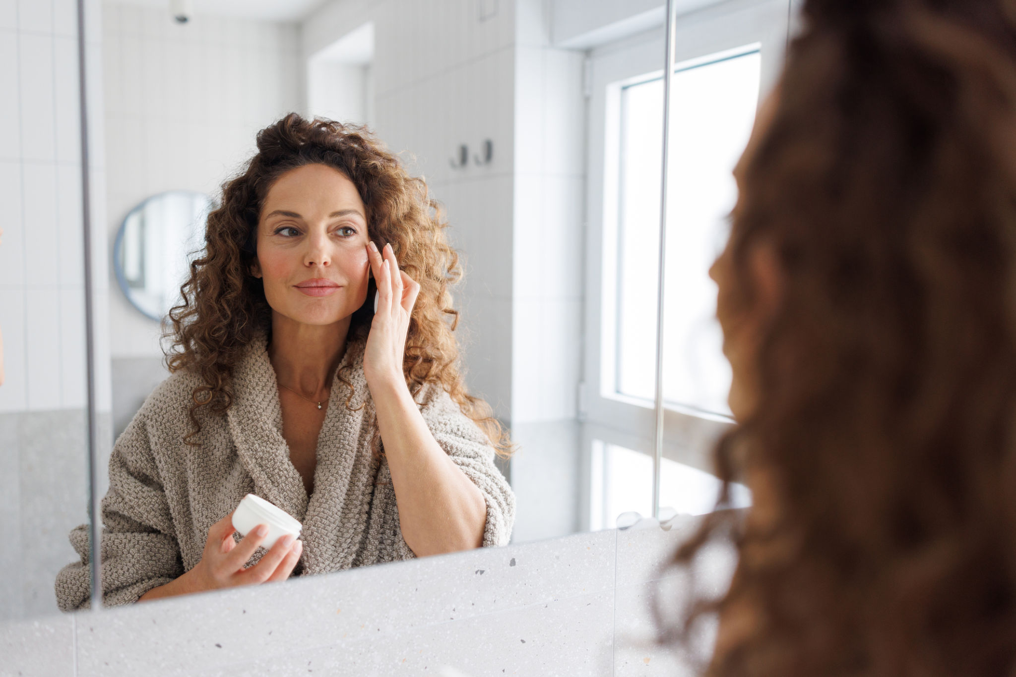 Woman discussing facial changes and skin health during an aesthetic consultation